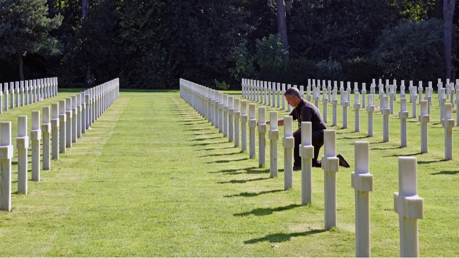 Dr. Brian DeToy pays his respects at the Normandy American Cemetery above OMAHA Beach, site of D-Day landings in WWII.