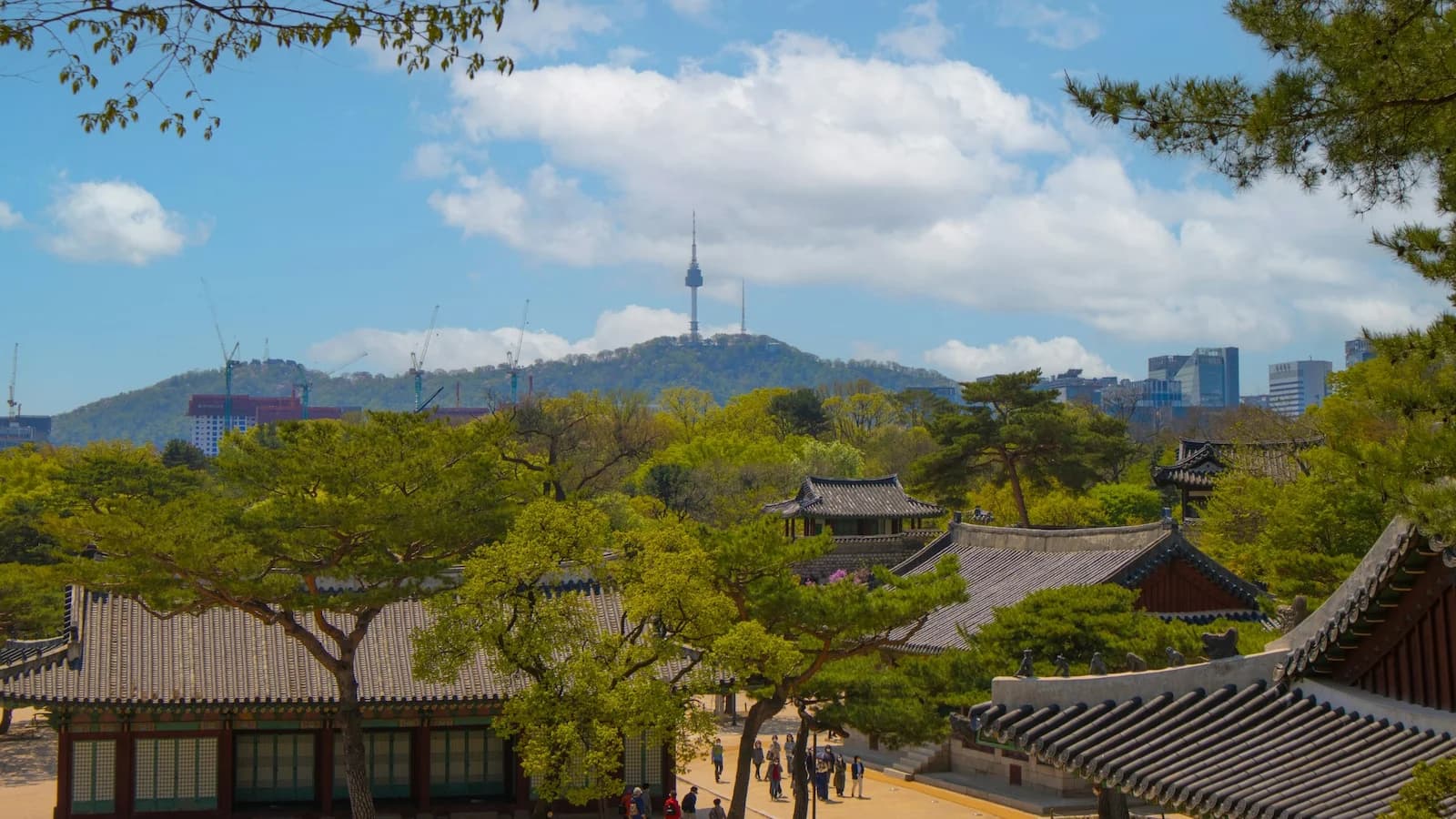 Iconic Seoul skyline with North Seoul Tower atop Namsan Mountain overlooking the city, showcasing the blend of tradition and modernity on Essential History Expeditions’ Essential Korea tour.
