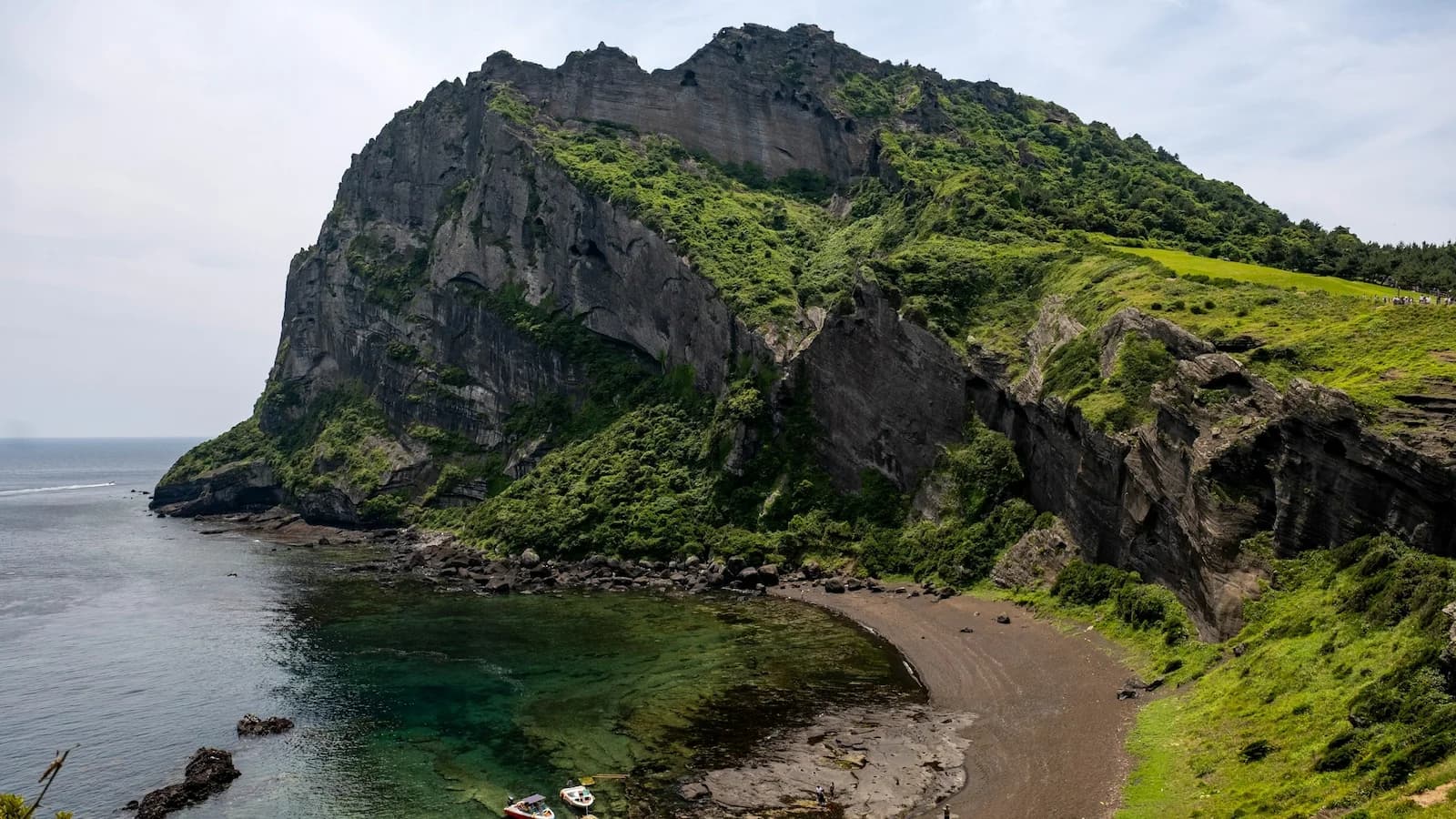 Dramatic volcanic coastline and cliffs of Jeju Island, showcasing the island’s unique geological beauty formed by ancient eruptions during the Jeju pre-trip extension with Essential History Expeditions.