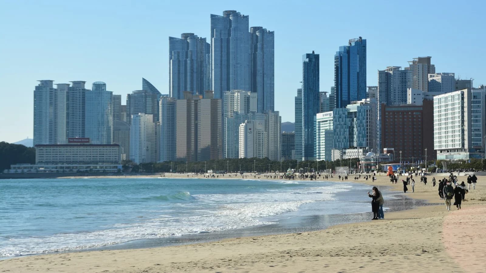 Beautiful Haeundae Beach with modern Busan skyline in the background, a relaxing highlight of the free day on Essential History Expeditions’ Korea history and culture tour.