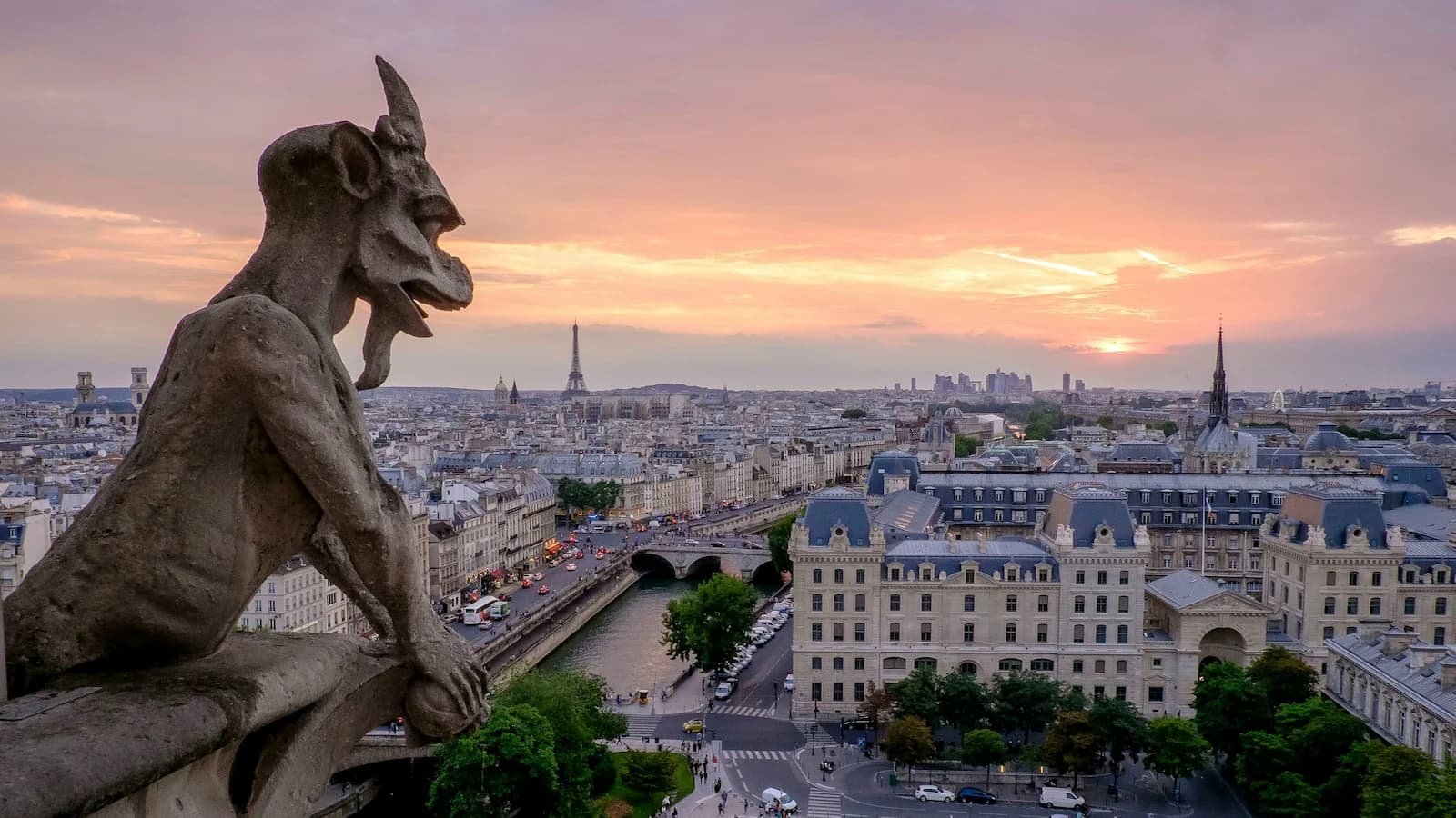 Panoramic sunset view of Paris from Notre Dame Cathedral with the Eiffel Tower and Notre-Dame Cathedral gargoyles, the final destination of our D-Day England to Normandy journey.