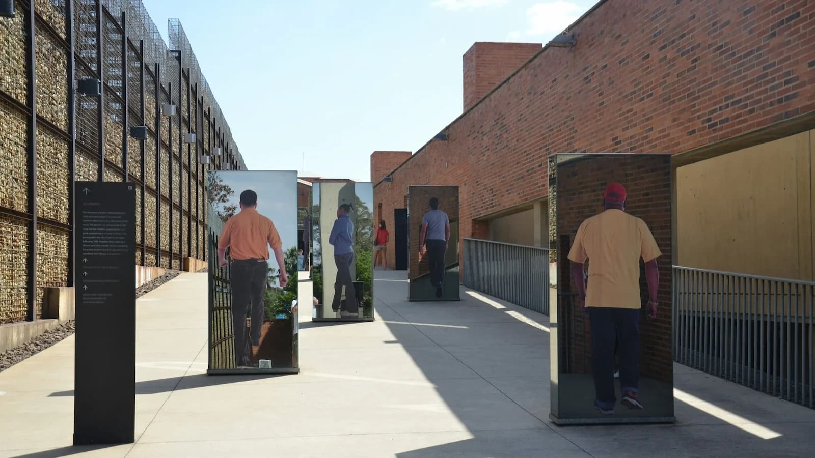 Exterior walkway with powerful reflective installations at the Apartheid Museum in Johannesburg, a deeply moving highlight of the South Africa history tour exploring Nelson Mandela and the path to democracy.