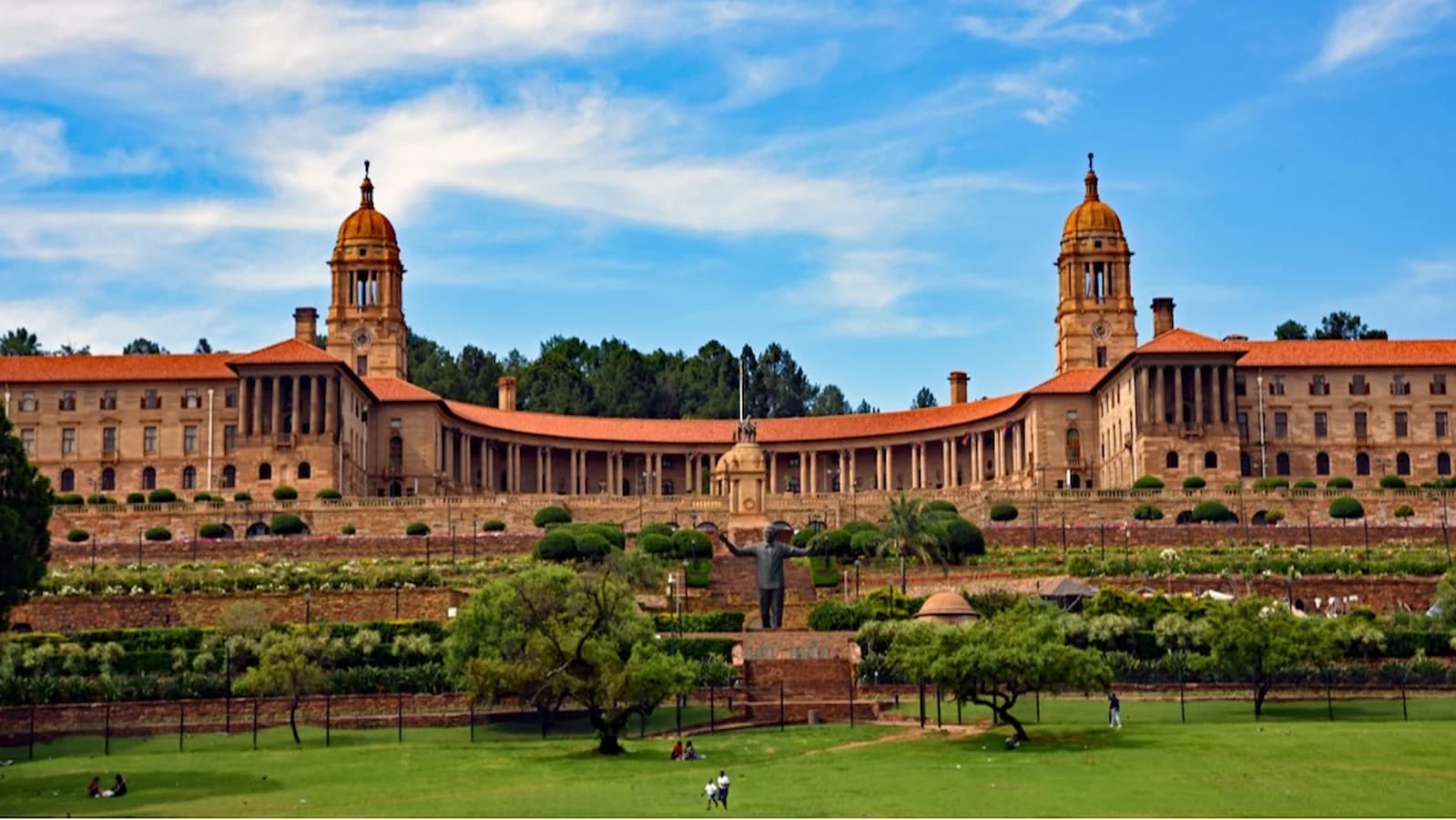 Sweeping view of the historic Union Buildings in Pretoria with the Nelson Mandela statue in the foreground, seat of government and key site visited during the Mandela legacy portion of the tour.