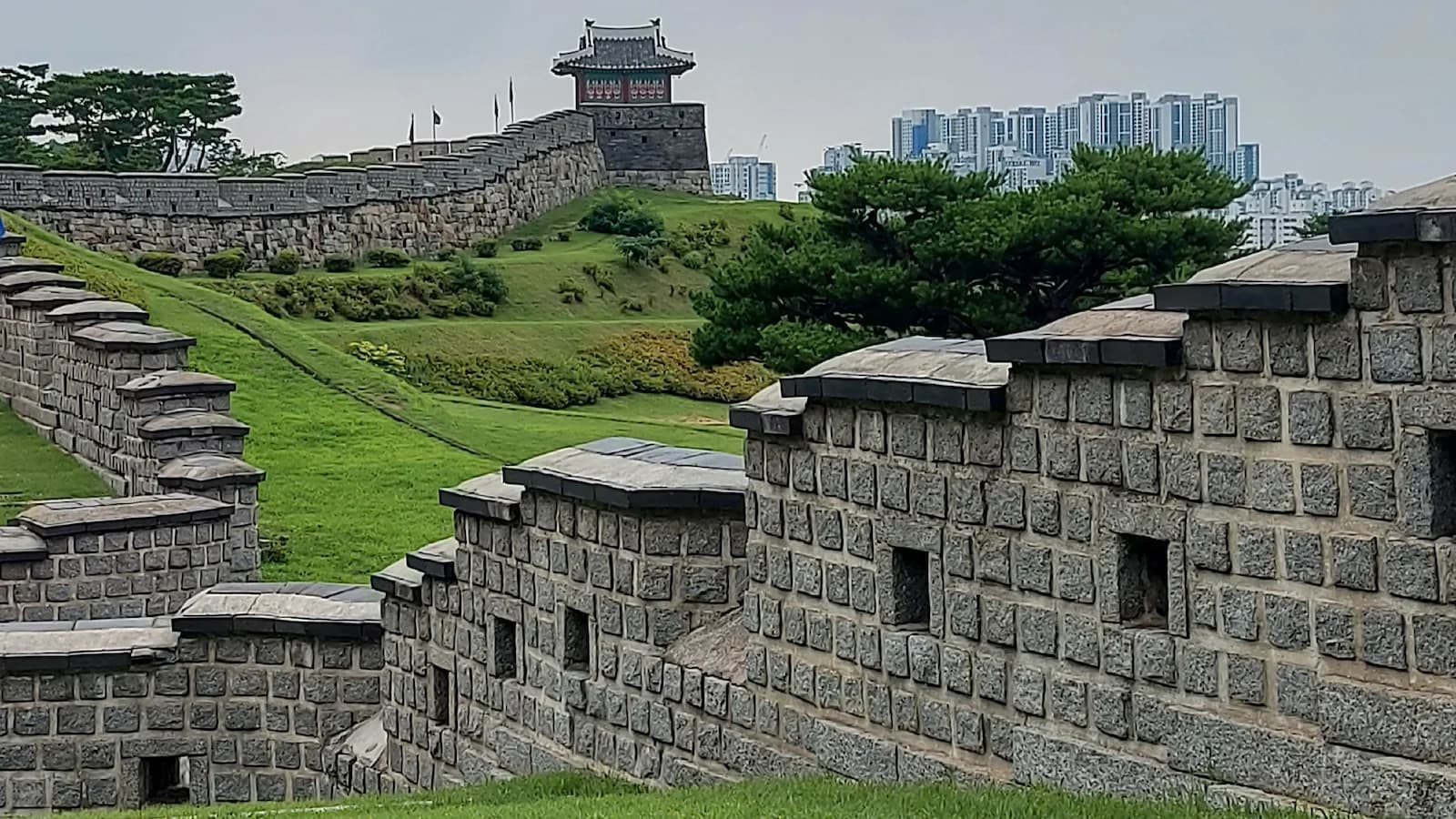Historic stone walls and watchtower of Suwon Hwaseong Fortress, a UNESCO World Heritage Site blending traditional Korean and Western military architecture, visited during Essential History Expeditions’ Essential Korea tour.