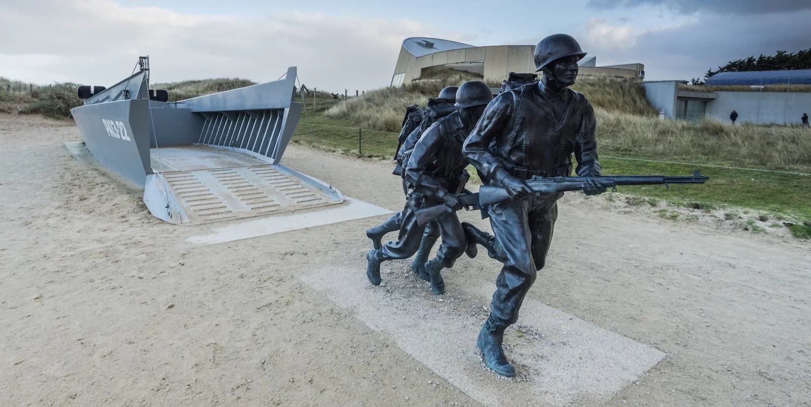 Bronze sculpture of American soldiers storming ashore from a Higgins landing craft at Utah Beach, Normandy. This powerful memorial honors the U.S. 4th Infantry Division troops who landed here on D-Day, June 6, 1944.