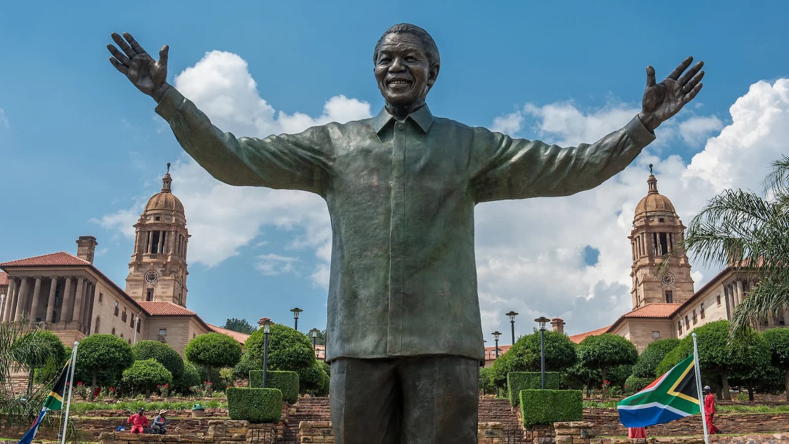 Iconic bronze statue of Nelson Mandela with outstretched arms at the Union Buildings in Pretoria, a powerful symbol of reconciliation and freedom on this South Africa history tour.