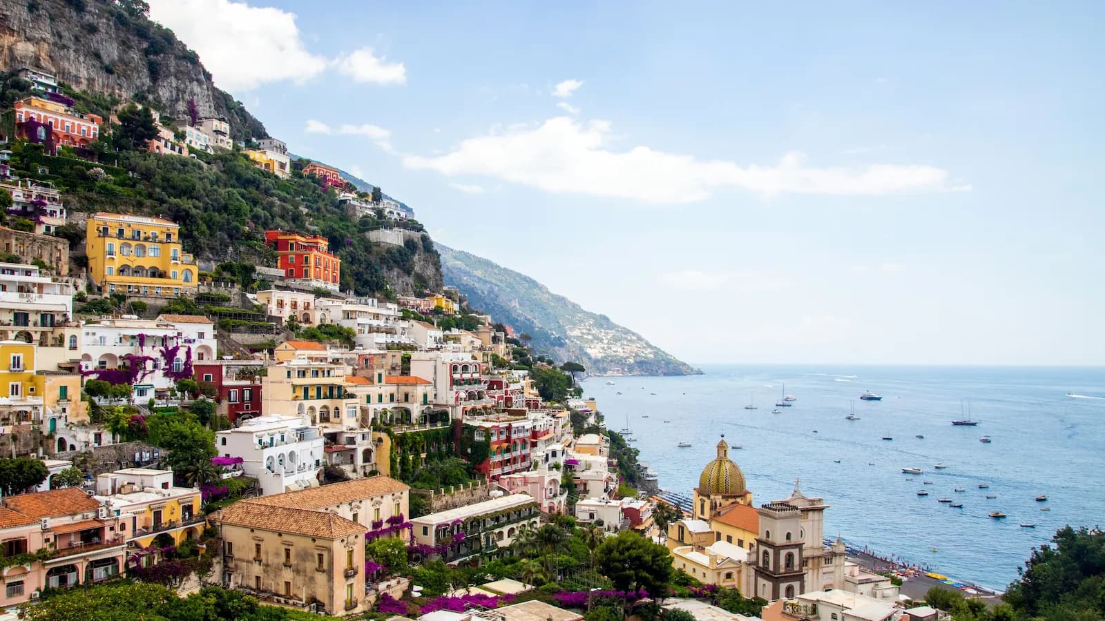 Iconic panoramic view of Amalfi and the dramatic Amalfi Coast, with its pastel-colored buildings clinging to steep cliffs overlooking the Tyrrhenian Sea. Explored during our Italian campaign tour.