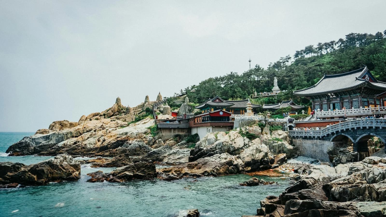 Haedong Yonggungsa Temple dramatically perched on the rocky coastline, one of Korea’s most picturesque seaside Buddhist temples visited during the Busan free day on Essential History Expeditions’ tour.