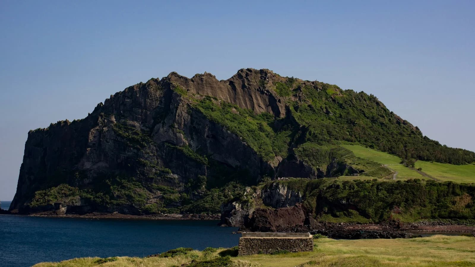 Seongsan Ilchulbong (Sunrise Peak), the iconic volcanic tuff cone and UNESCO World Natural Heritage site on Jeju Island, visited during Essential History Expeditions’ Jeju pre-trip extension.