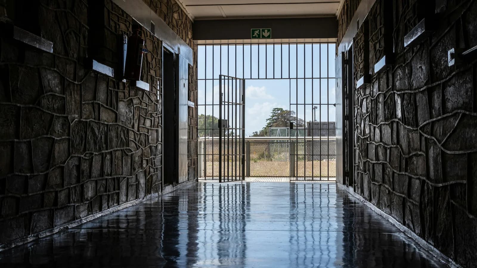 Interior prison corridor at Robben Island with open cell doors, the historic site where Nelson Mandela was imprisoned for 18 years during this South Africa history tour.