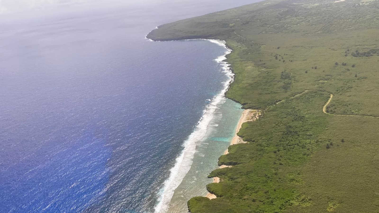 Aerial view of the northern coastline of Tinian in the Mariana Islands. This island was a critical U.S. base in 1945, from which the atomic bombing missions against Hiroshima and Nagasaki were launched during the final months of World War II.