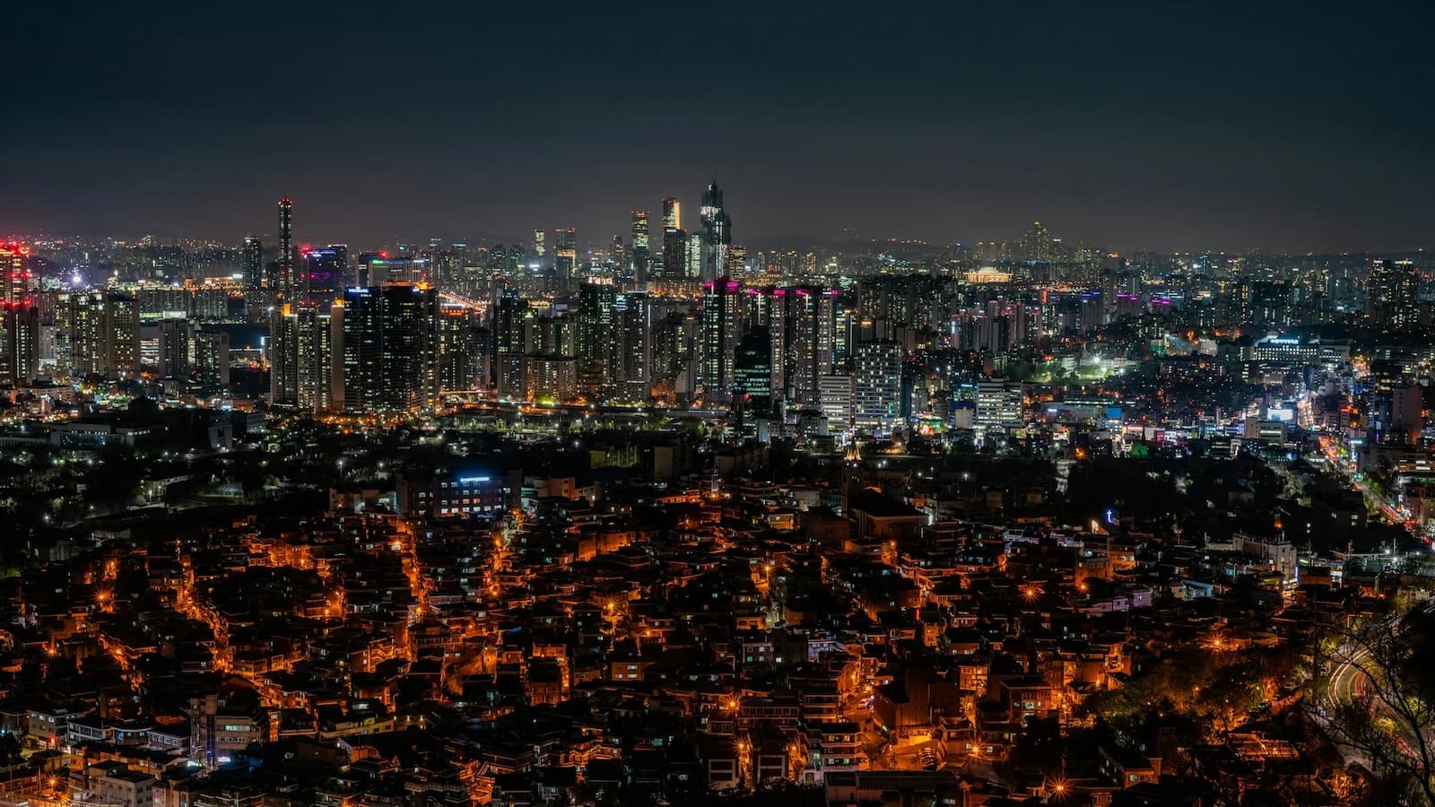 Panoramic nighttime view of Seoul’s illuminated skyline, showcasing the vibrant modern capital that concludes Essential History Expeditions’ Essential Korea: Seoul, Culture & the Korean War tour.