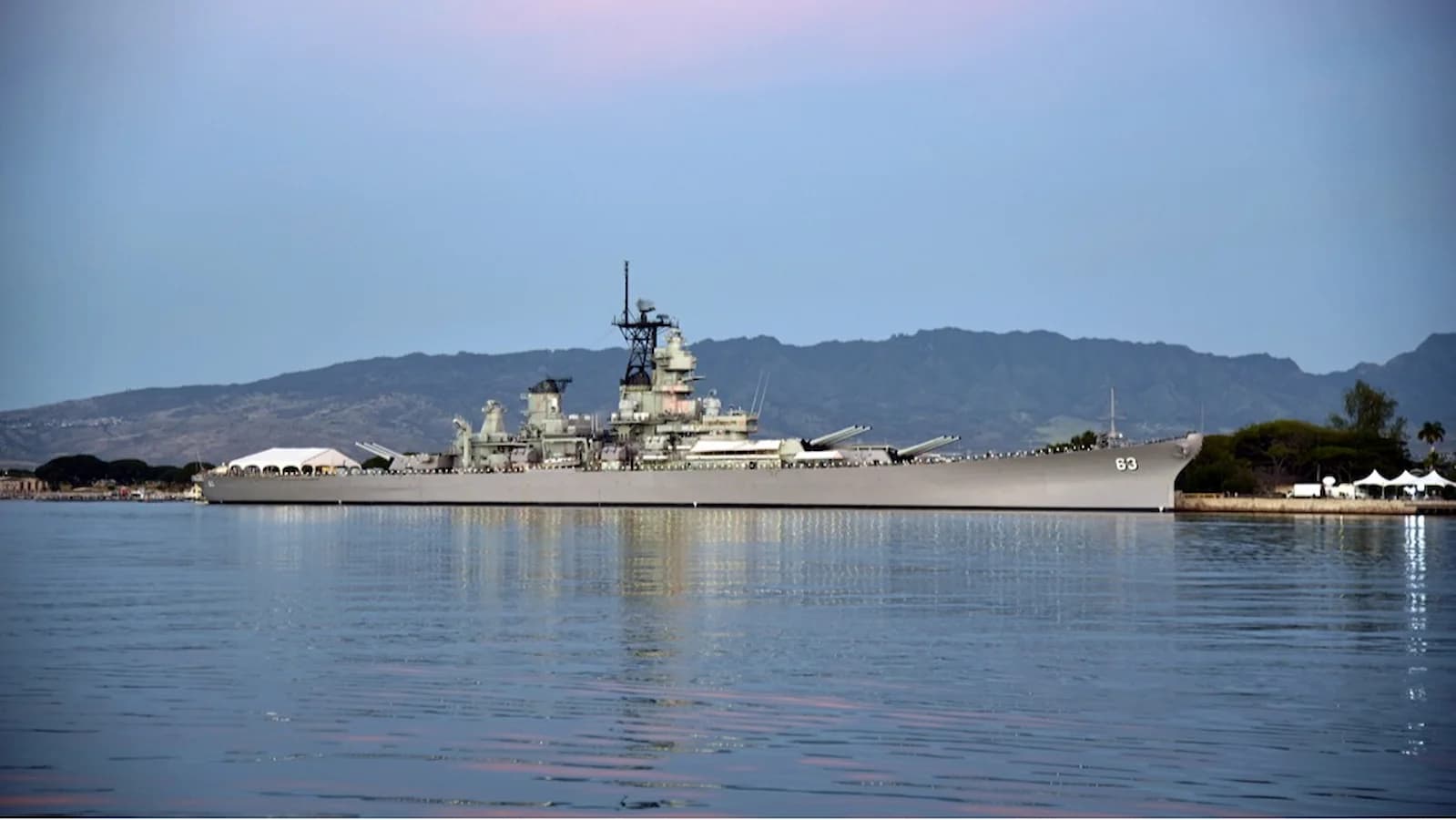 Sunrise illuminating the USS Missouri in Pearl Harbor, Hawaii. The deck where the Japanese surrender was signed on September 2, 1945, officially ending World War II.
