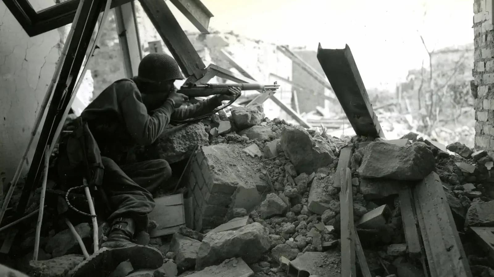 Soldier from the 3rd Infantry Division standing amid the ruins of Cisterna, Italy, in May 1944 after the town was finally secured. Cisterna was the scene of the costly Ranger assault earlier in the Anzio campaign.