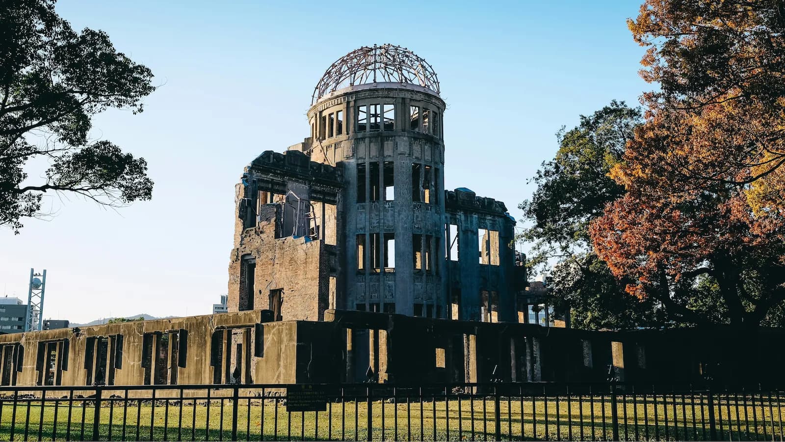 The skeletal ruins of the Atomic Bomb Dome in Hiroshima, the final stop on our journey from Pearl Harbor. The image shows the crumbling brick and exposed iron dome of the former Industrial Promotion Hall, preserved as a permanent memorial to the victims of the August 6, 1945, bombing that ended the Pacific War.